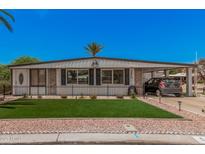 Charming single-story home featuring a well-manicured lawn and covered parking at 506 S 81St Pl, Mesa, AZ 85208
