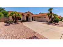 Inviting single-story home featuring a red tile roof and manicured desert landscaping at 6325 E Helm Dr, Scottsdale, AZ 85254