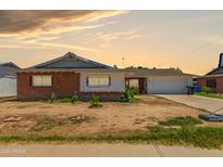 Charming single-story brick home featuring an attached garage and lovely desert landscaping at 6541 N 41St Ave, Phoenix, AZ 85019