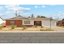 Charming single-story home with a brick exterior, well-maintained lawn, and a classic, welcoming aesthetic at 6541 N 41St Ave, Phoenix, AZ 85019
