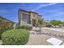 Two-story home featuring desert landscaping, stone accents, neutral paint, and a covered front porch entry at 742 W Agrarian Hills Dr, San Tan Valley, AZ 85143