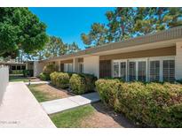 Inviting home exterior featuring lush landscaping, a well-maintained walkway, and a charming facade under a clear blue sky at 7740 E Heatherbrae Ave # 3, Scottsdale, AZ 85251