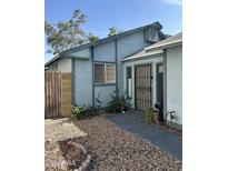 Charming single story home exterior with a secure front door and low-maintenance desert landscaping at 8155 W Desert Cove Ave, Peoria, AZ 85345