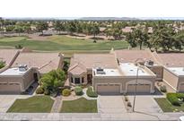 Charming single-story home featuring a tile roof, manicured lawn, and a two-car garage at 8431 W Utopia Rd, Peoria, AZ 85382
