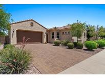 Inviting single-story home with a two-car garage and manicured landscaping at 10914 E Tarragon Ave, Mesa, AZ 85212
