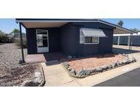 Charming manufactured home featuring tasteful gravel landscaping and covered entry for added curb appeal at 11000 N 91St Ave # 84, Peoria, AZ 85345