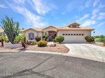 Charming single-story home with a two-car garage and well-manicured desert landscaping at 15377 W Catalina Ct, Goodyear, AZ 85395