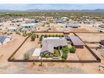 Expansive aerial view of a fenced home featuring a metal storage shed and desert landscaping at 15438 E Milton Dr, Scottsdale, AZ 85262