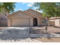 Charming single-story home with a well-maintained lawn, two car garage, and inviting front entrance at 1718 E Harwell Rd, Phoenix, AZ 85042