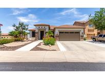 Beautiful single-story home featuring a well-manicured landscape, stone accents, and a tile roof at 17664 W Marshall Ln, Surprise, AZ 85388