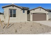 Charming single-story home featuring a two-car garage, neutral stucco, and low-maintenance desert landscaping at 19028 W Rose Ln, Waddell, AZ 85355