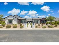 Beautiful single Gathering home with desert landscaping and stone accents on a sunny day with blue skies at 2630 E Lovebird Ln, Gilbert, AZ 85297