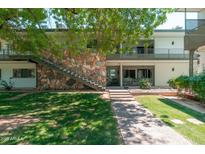 Charming two-story condo with stone accents, stairs to the second level, and lush landscaping at 330 W Maryland Ave # 207, Phoenix, AZ 85013