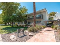 Well-maintained building with lush landscaping and inviting walkway provides a welcoming atmosphere at 330 W Maryland Ave # 207, Phoenix, AZ 85013