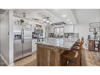 Charming kitchen with granite counters, stainless appliances, and white cabinetry at 4822 N 63Rd Ln, Phoenix, AZ 85033