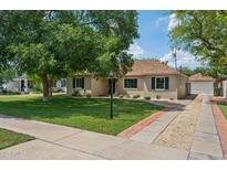 Charming home showcasing a well-manicured lawn and mature trees, offering great curb appeal at 522 W Cambridge Ave, Phoenix, AZ 85003