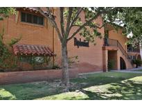 Brick building with mature trees and grass lawn, and tile window coverings in a clean apartment complex at 5246 N 20Th St # B1, Phoenix, AZ 85016