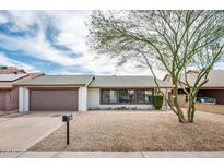 Charming single-story home with gravel landscaping, two-car garage and shade tree at 6627 S 42Nd Pl, Phoenix, AZ 85042