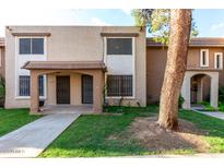 Charming townhouse featuring a cozy porch and well-maintained landscaping at 7126 N 19Th Ave # 228, Phoenix, AZ 85021