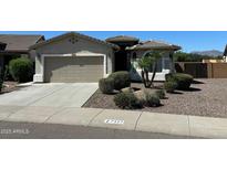 Charming single-story home featuring well-manicured landscaping and an attached two-car garage at 7327 W Donner Dr, Laveen, AZ 85339