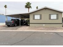 Inviting mobile home with covered parking, desert landscaping and a paved drive way in a well maintained community at 8218 S 7Th St # Ofc, Phoenix, AZ 85042