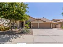 Charming single-story home with a well-maintained yard, desert landscaping, and a two-car garage at 10794 S Coolwater Dr, Goodyear, AZ 85338
