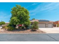 Charming desert home with a tile roof, solar panels and a meticulously xeriscaped front yard at 13034 W Krall Ct, Glendale, AZ 85307