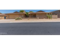 Charming single-story brick home featuring desert landscaping, a front patio, and an attached two-car garage at 132 W Wood Dr, Phoenix, AZ 85029