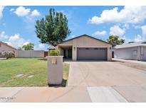 Charming single-story home with a well-manicured lawn and a spacious two-car garage at 1417 W Los Arboles Pl, Chandler, AZ 85224
