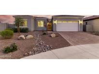Charming single-story home featuring desert landscaping and a paved driveway leading to an attached two-car garage at 17721 W Sandalwood Dr, Goodyear, AZ 85338
