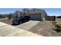 Charming single-story home featuring low-maintenance landscaping, a two-car garage, and stone accents at 19929 W Marshall Ave, Litchfield Park, AZ 85340