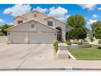 Inviting two-story home featuring a three-car garage and manicured front yard at 2258 N Gentry --, Mesa, AZ 85213