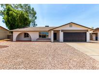 Charming single-story home with a two-car garage and low-maintenance desert landscaping at 3021 W Angela Dr, Phoenix, AZ 85053