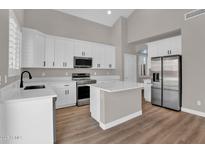 Bright kitchen features white cabinetry, stainless steel appliances, and a center island with quartz countertops at 3376 E Lafayette Ave, Gilbert, AZ 85298