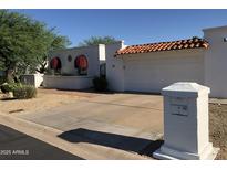 Charming single-story home with white exterior, barrel tile roof, and easy to maintain landscaping at 38 E Calavar Rd, Phoenix, AZ 85022