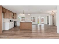 Bright, open kitchen featuring modern cabinets, a center island, and stainless steel appliances at 3910 W Kings Ave, Phoenix, AZ 85053