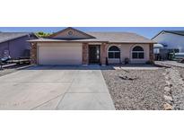 Charming single-story home featuring a spacious driveway, two car garage, and inviting curb appeal at 450 N 110Th St, Mesa, AZ 85207