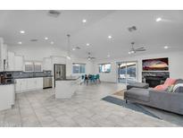 Bright and open living space with modern finishes, featuring a kitchen, dining area, fireplace and comfortable lounge area at 6201 E Waltann Ln, Scottsdale, AZ 85254