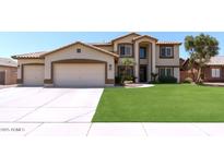Charming two-story home featuring a well-manicured lawn and a spacious three-car garage at 1125 E San Carlos Way, Chandler, AZ 85249