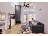 Spacious living room featuring a brick fireplace, a fan, and lots of natural light at 11333 N 92Nd St # 1118, Scottsdale, AZ 85260