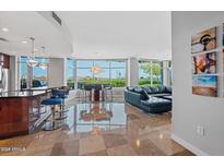 Bright living room boasts an open floorplan, modern furnishings, and expansive windows offering scenic views at 120 E Rio Salado E Pkwy # 102, Tempe, AZ 85281