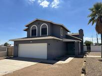 Charming two-story home with a two-car garage and arched windows at 121 N Brown Ave, Casa Grande, AZ 85122