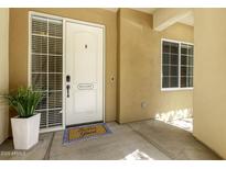 Inviting front entrance with a white door, decorative welcome mat, and a charming sidelight window at 121 N California St # 35, Chandler, AZ 85225