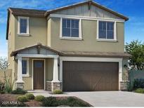 Inviting two-story home with a covered entrance and an attached two-car garage at 13195 N 145Th Ln, Surprise, AZ 85379