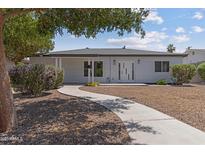 Charming single-story home with a curving walkway, desert landscaping, and modern architectural design at 1367 E Mitchell Dr, Phoenix, AZ 85014
