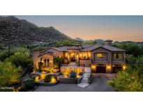 Inviting exterior elevation with meticulously landscaped yard and illuminated by strategically placed outdoor lighting at 14598 E Corrine Dr, Scottsdale, AZ 85259