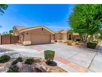 Charming single-story home with desert landscaping, a two-car garage, and a private gate at 1865 E Locust Pl, Chandler, AZ 85286