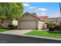 Charming single-story home with a two-car garage, well-maintained lawn, and attractive landscaping at 18780 N 94Th Ave, Peoria, AZ 85382