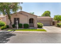 Charming single-story home features a well-manicured lawn and an attached two-car garage at 2063 S Edgewater --, Mesa, AZ 85209