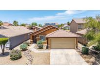 Charming home featuring desert landscaping, a two-car garage, and a tile roof in a sunny neighborhood at 25840 W Whyman St, Buckeye, AZ 85326